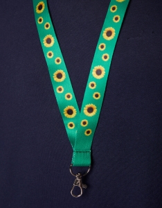 A green lanyard with sunflowers